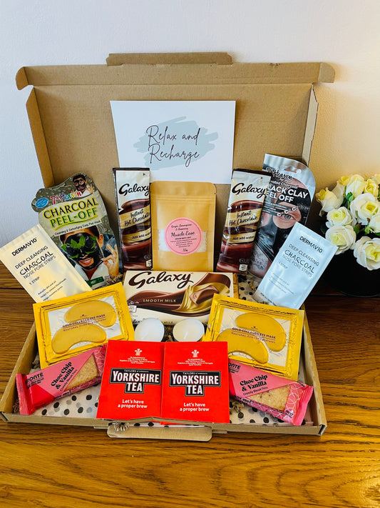 A letterbox Gift filled with various self-care items, including 2 face sheet masks, gold collagen under eye masks, either a Cadbury or Galaxy Chocolate Bar, 2 Yorkshire tea bags, 2 Tea Light candles, 2 Nose Pore Strips, 2 Hot Chocolate Sachets,  Epsom Bath Salts and 2 packs of Brontë Biscuits. With an option of gift cards and your own personalised message delivered straight to the recipient