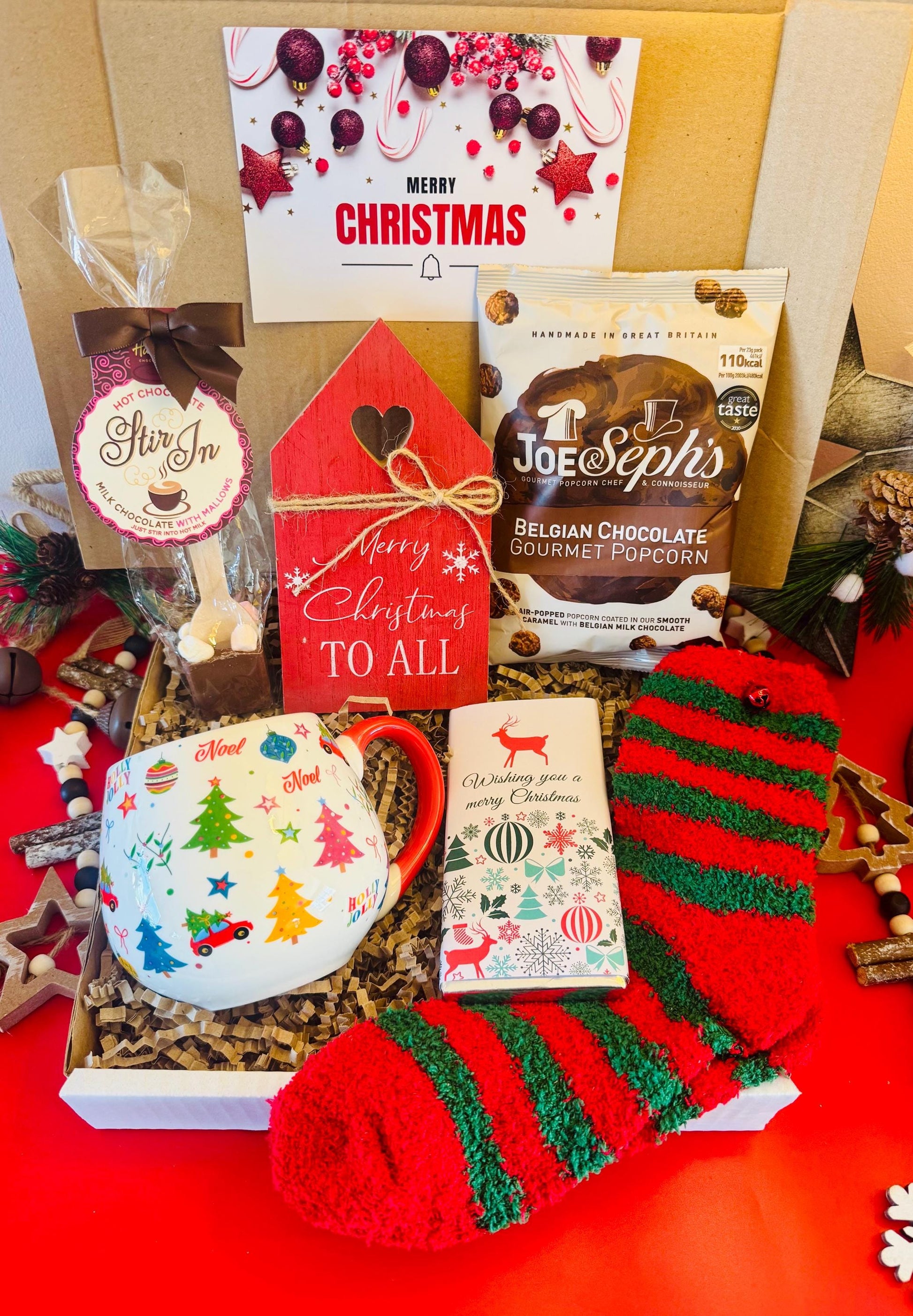 our Ladies Christmas Hamoer comes with a Christmas cup, cosy red and green socks, hot chocolate stirrer, chocolate flavoured popcorn, merry Christmas chocolate bar and a wooden Christmas decoration. Comes gift wrapped with your own personalised message ready to send direct to the recipient