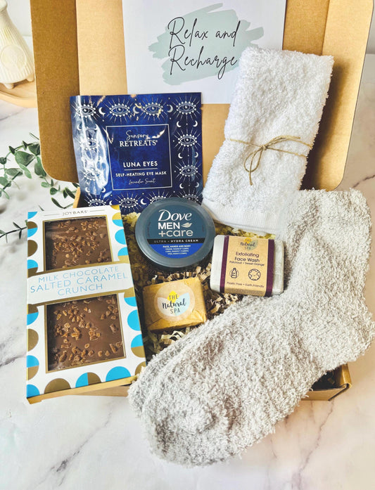 May include: A self-care gift box containing a bar of chocolate, an eye mask, face wash, Dove Men+Care Ultra Hydra Cream, a white towel, a pair of grey fuzzy socks, and a bar of soap. Comes complete with your own personalised message ready to send direct to the recipient