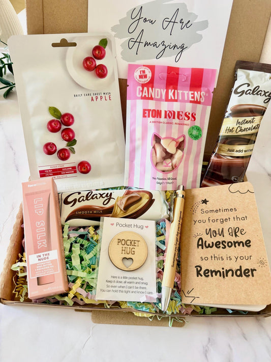 May include: A gift box containing a face mask, sweets, chocolate, lip silk, a pen a Mini notebook that says ‘Sometimes you forget you are awesome so this is your reminder, and a pocket hug. Includes gift card options with your own personalised message ready to dispatch direct to the recipient