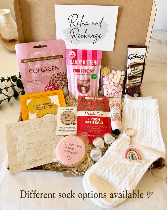 our hug in a box - includes white socks, hug biscuit, candy kitten sweets, hug token, rainbow keyring, self heating eye mask, gold collagen under eye masks, face sheet mask, hot chocolate sachet, mini marshmallows, bath salts, Handcream….ready to shit direct to the recipient