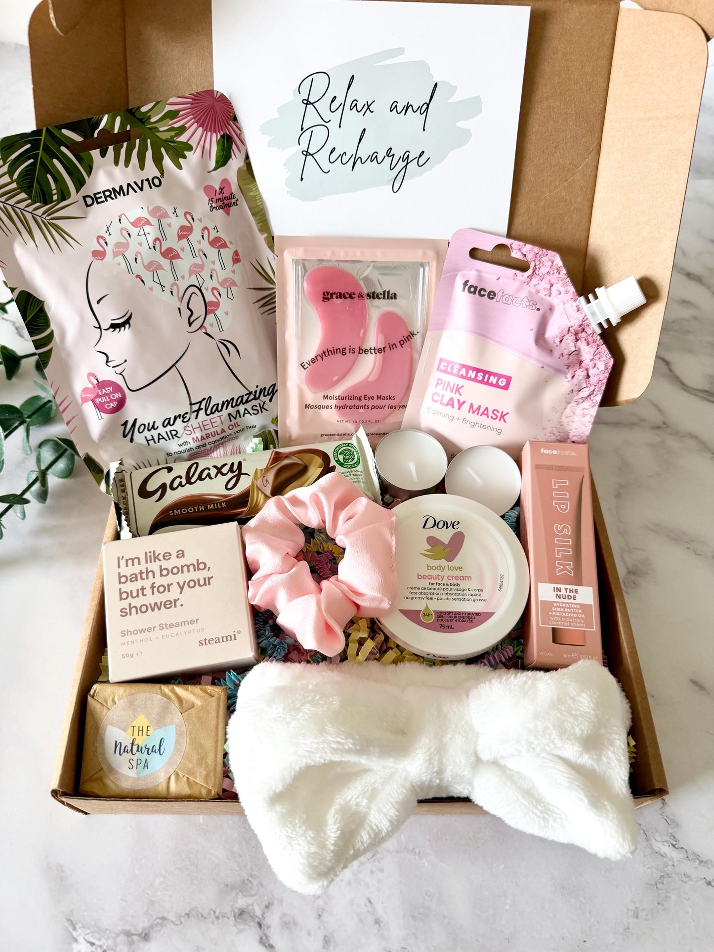 Our Spa Pamper Hamper includes hair sheet mask, shower steamer, travel soap, spa headband, dove body & face Cream, nude lip silk, hair scrunchie, under eye masks, clay face mask, spa headband, Galaxy chocolate bar and two tea light candles. with the option of your own gift card and a personalised message ready to send direct to the recipient