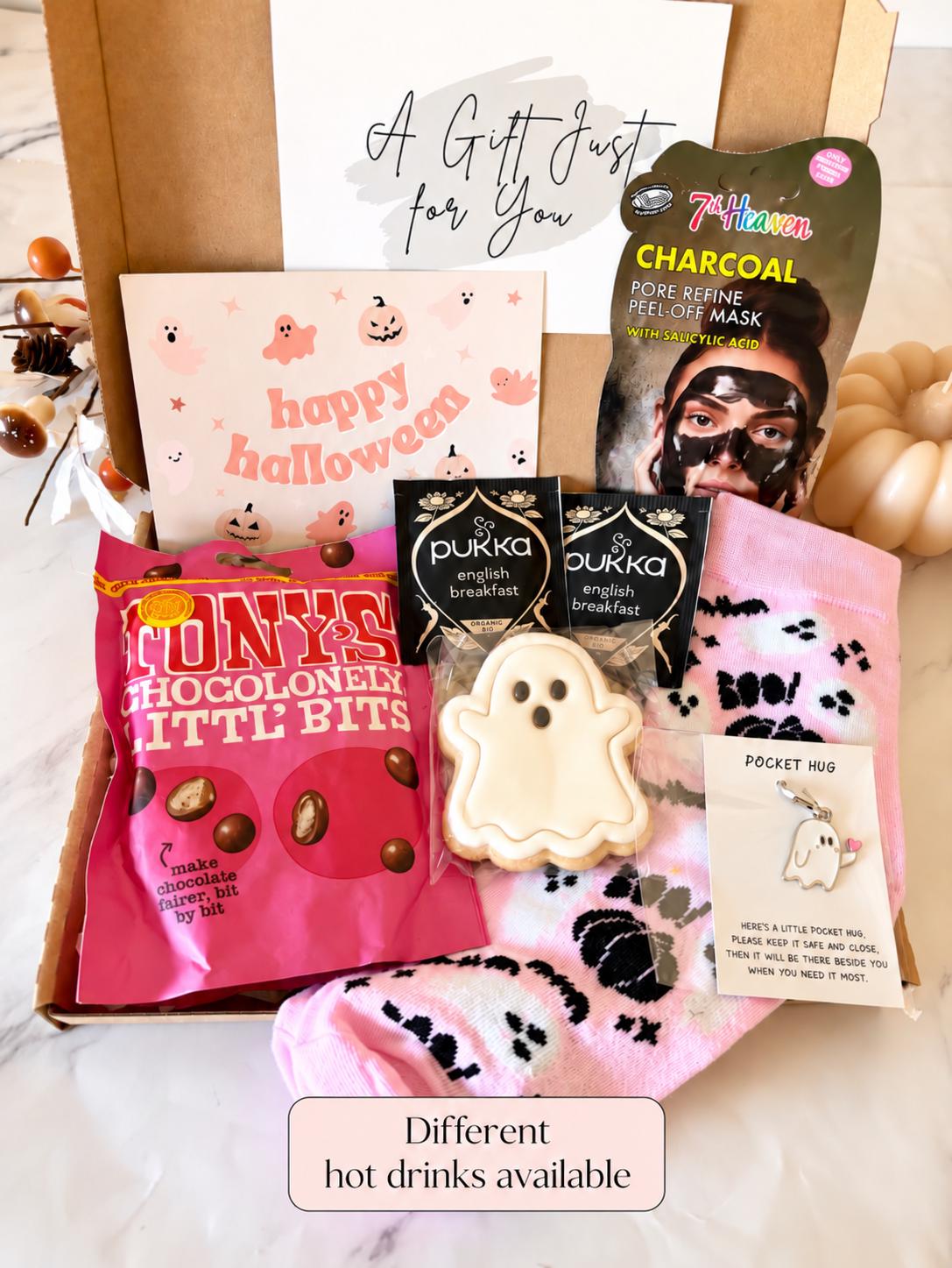 May include: A gift box containing a 7th Heaven charcoal peel-off mask, two Pukka English Breakfast tea bags, a ghost-shaped cookie, a pink pair of socks with ghost patterns, a Pocket Hug ghost charm, and a Happy Halloween card with ghosts.