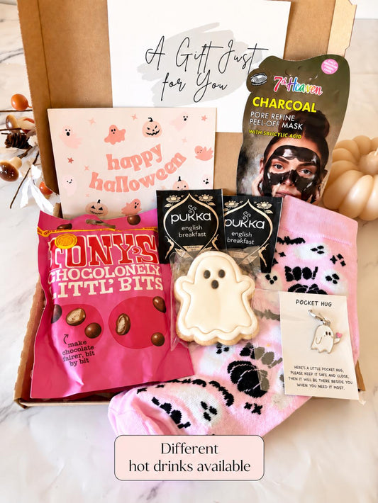May include: A gift box containing a 7th Heaven charcoal peel-off mask, two Pukka English Breakfast tea bags, a ghost-shaped cookie, a pink pair of socks with ghost patterns, a Pocket Hug ghost charm, and a Happy Halloween card with ghosts.